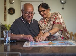sikh couple filling in jigsaw