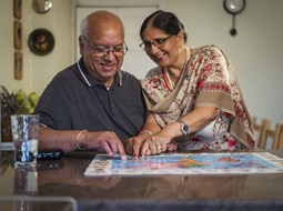 sikh couple filling in jigsaw