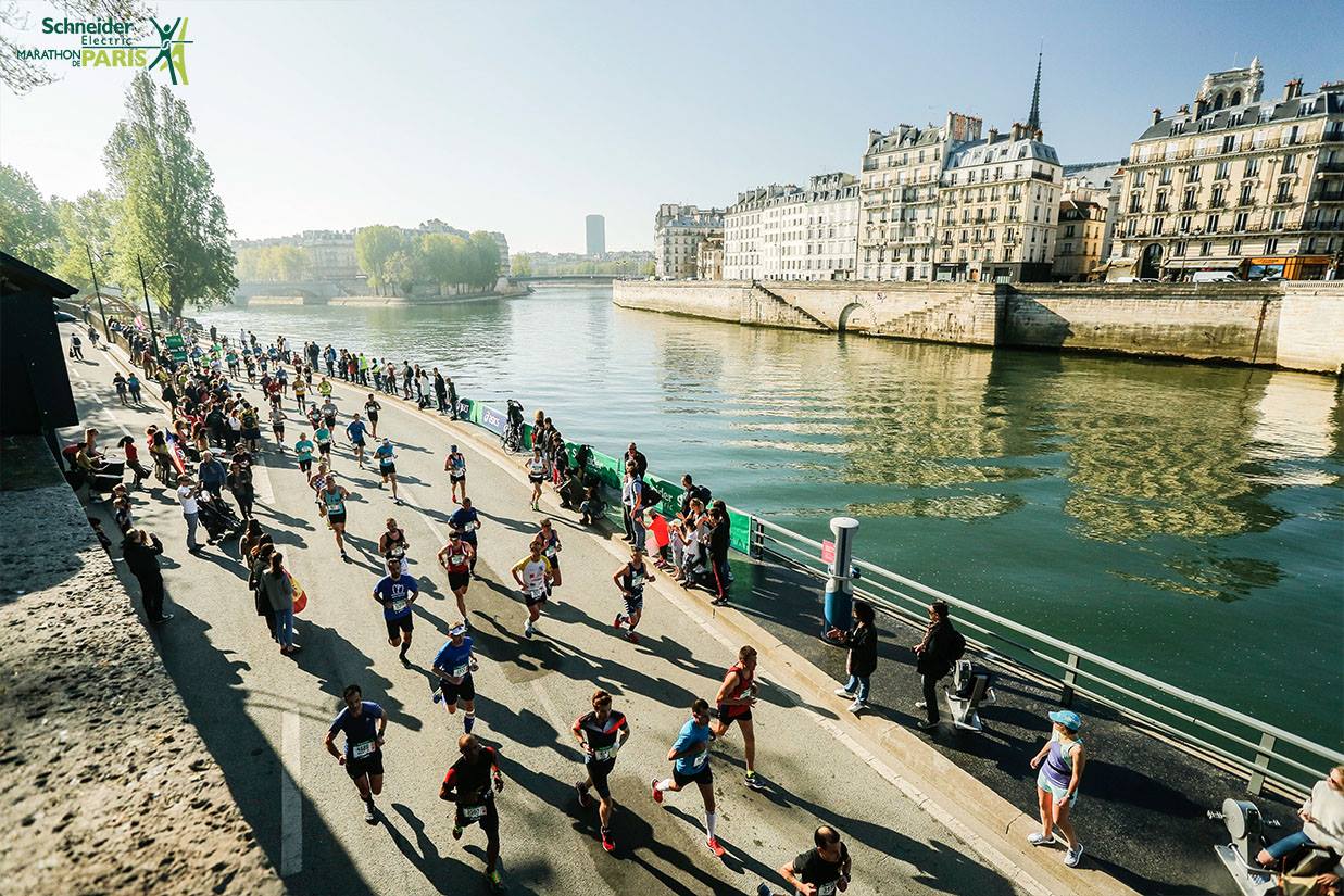 Runners running past the River Seine in Paris