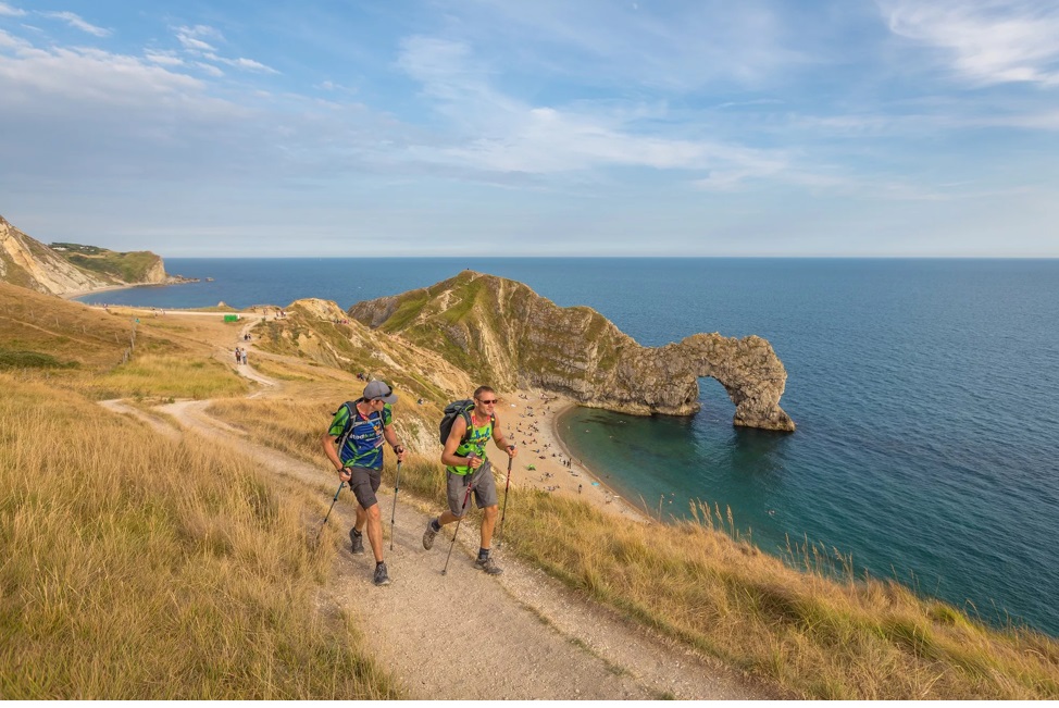 Walkers along Jurassic Coast and Durdle Door