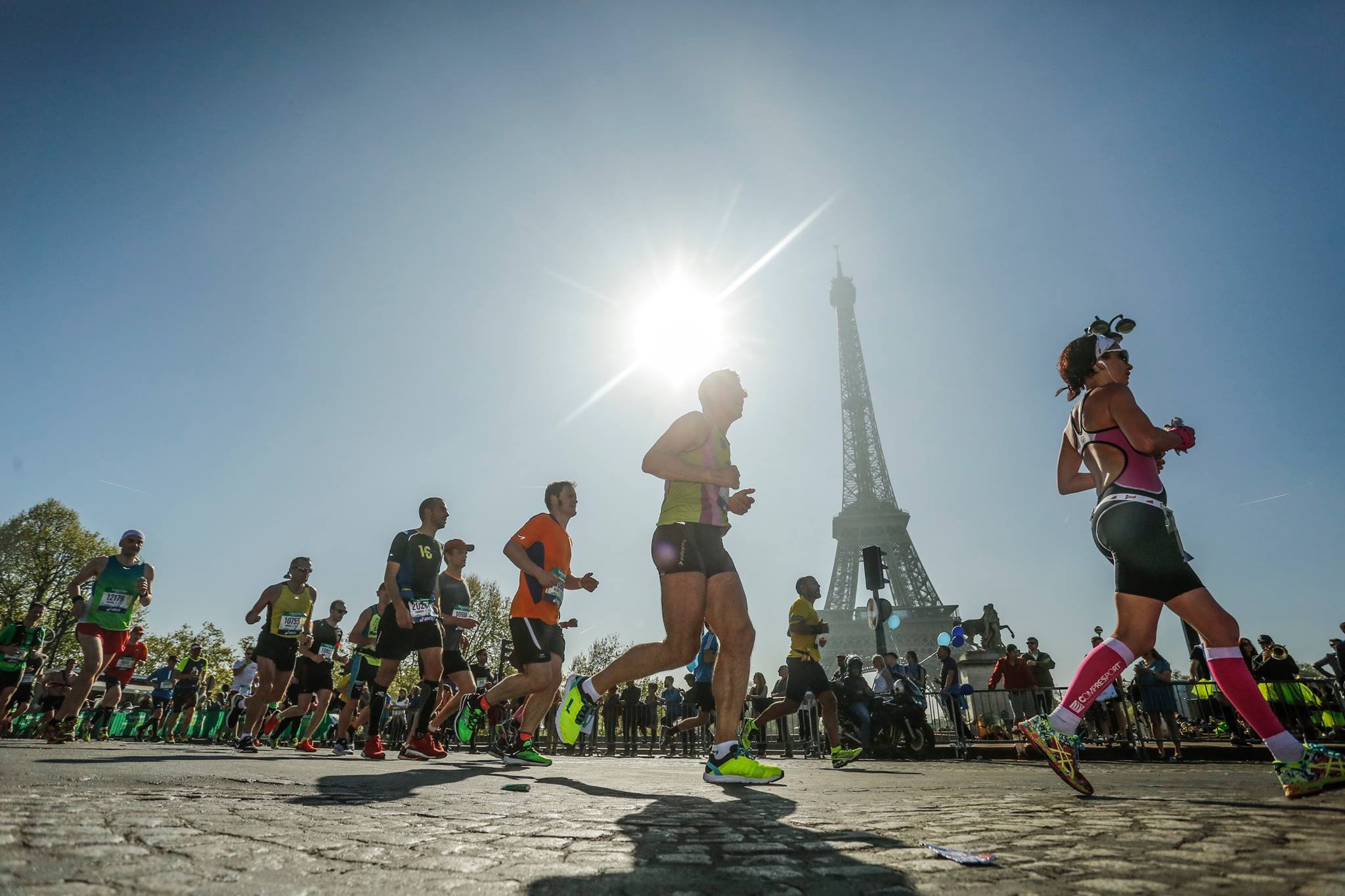 Runners running past the Eiffel Tower in Paris