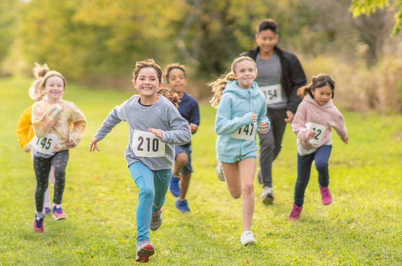 Kids running in a race in a park