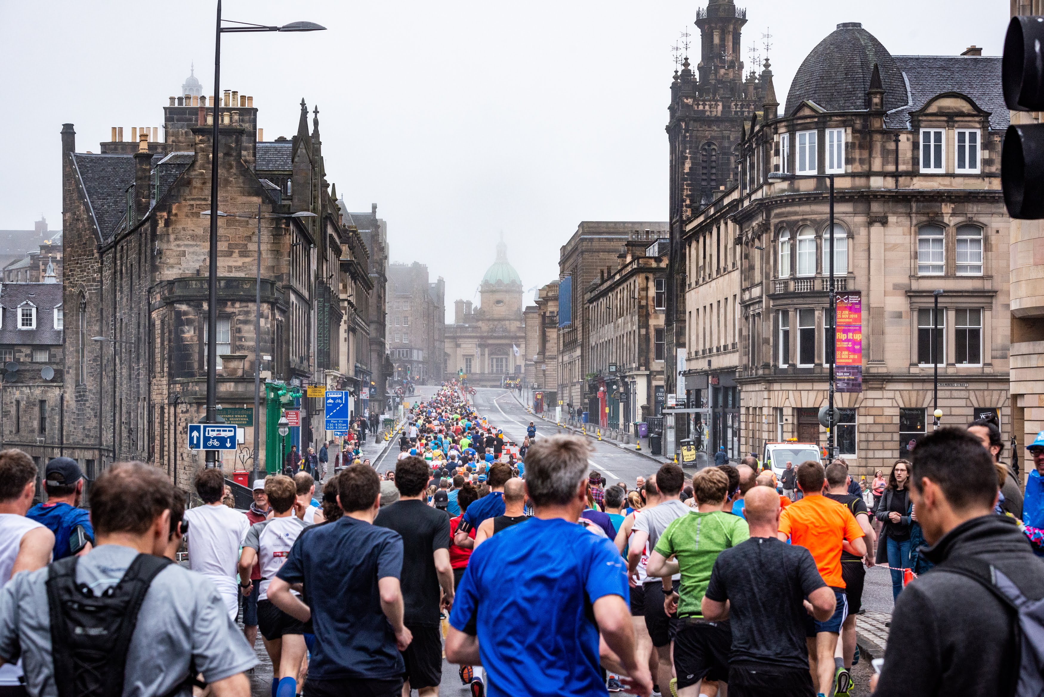 Runners racing through Edinburgh old town