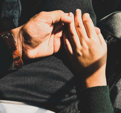 Two people holding hands